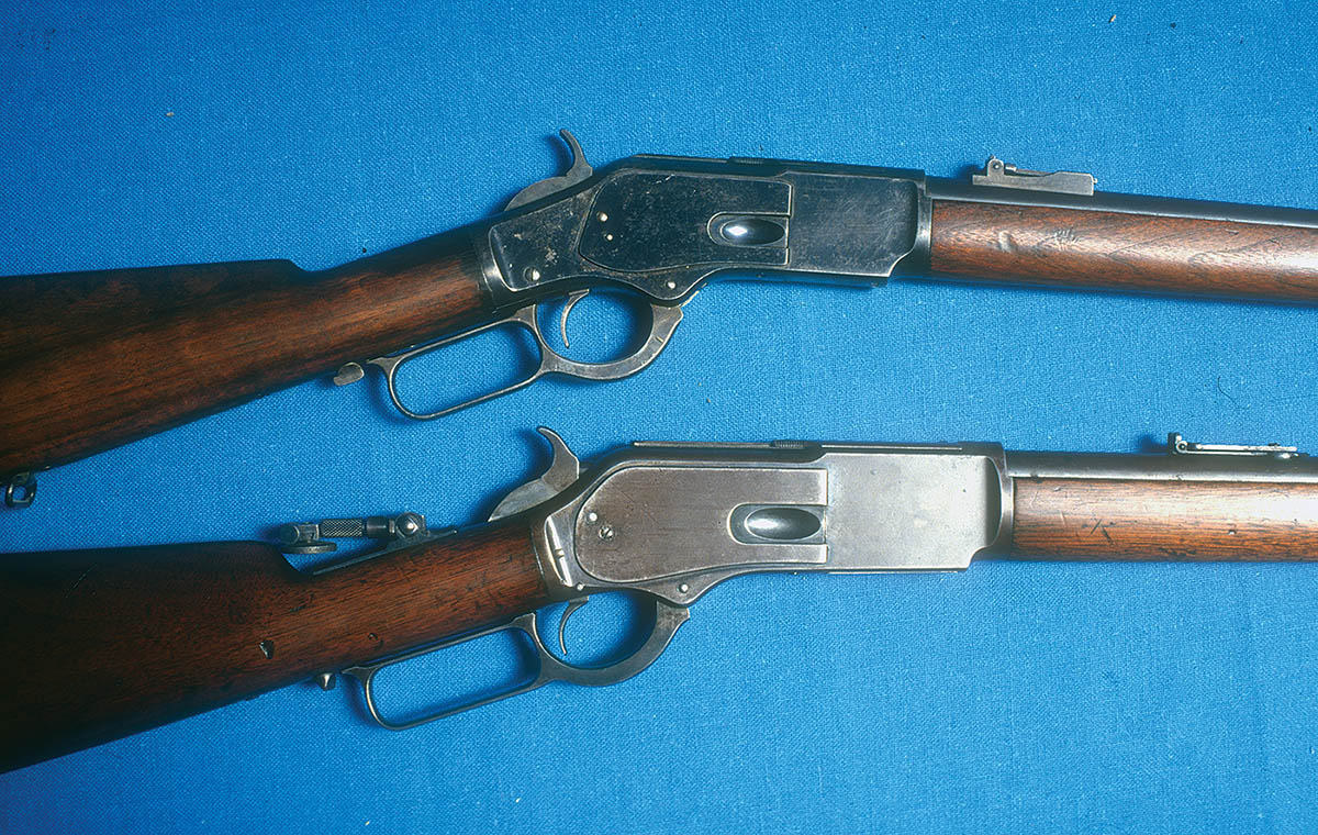 Winchester’s Model 1876 (bottom) was more or less a remodeled, larger version of the Model 1873 (top).